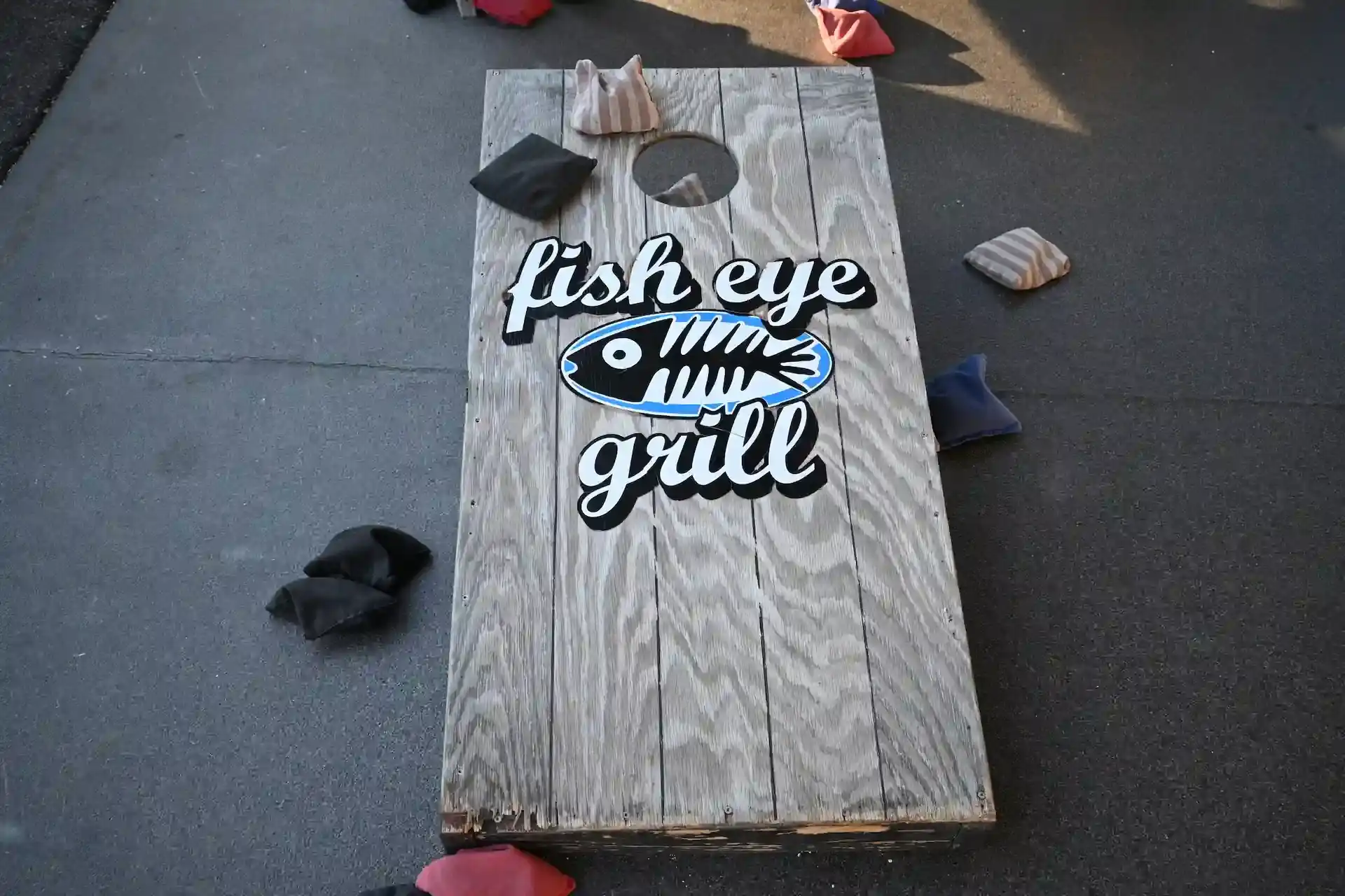 Cornhole board with bean bags