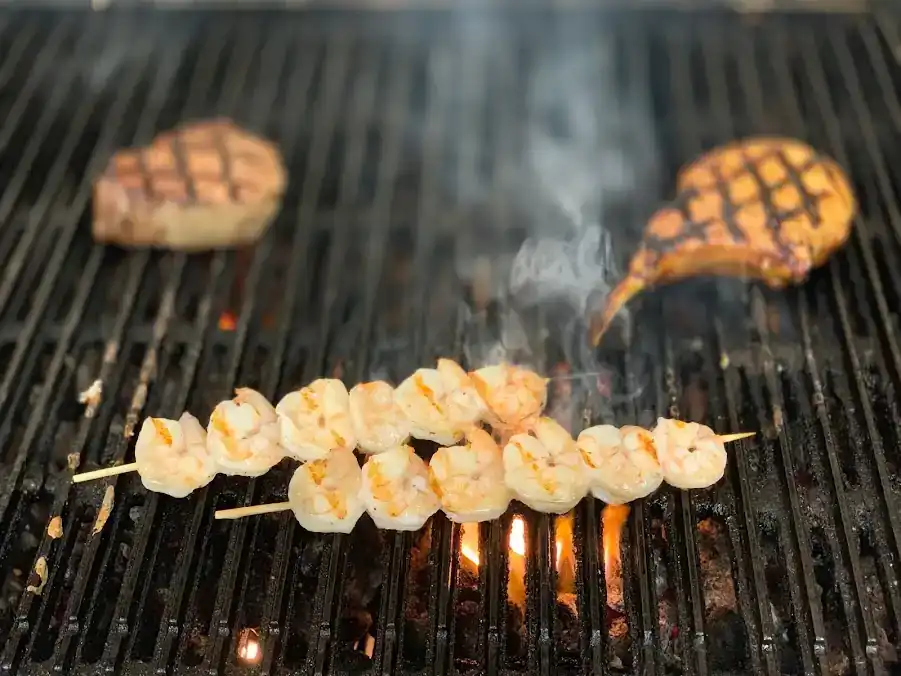 Shrimp and steaks on grill