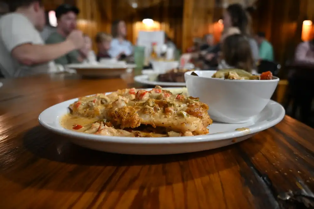 Grouper dish on a table with guests